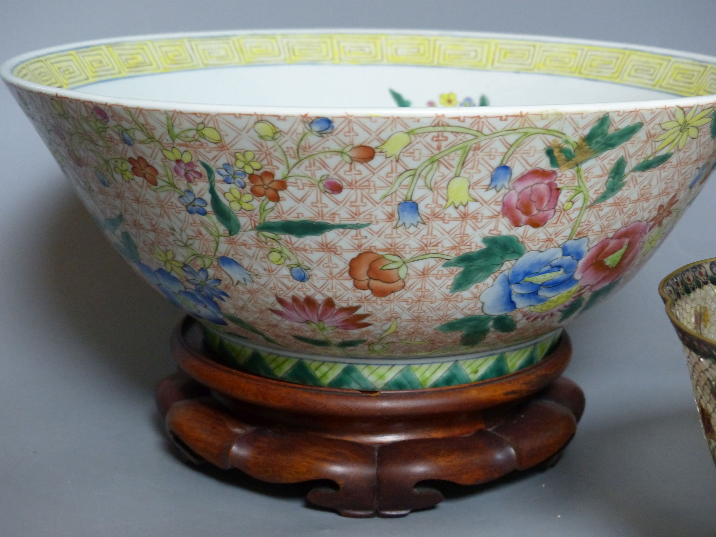 A Chinese plique a jour enamel bowl on stand, and a Chinese famille rose bowl on stand, largest 33cm diameter